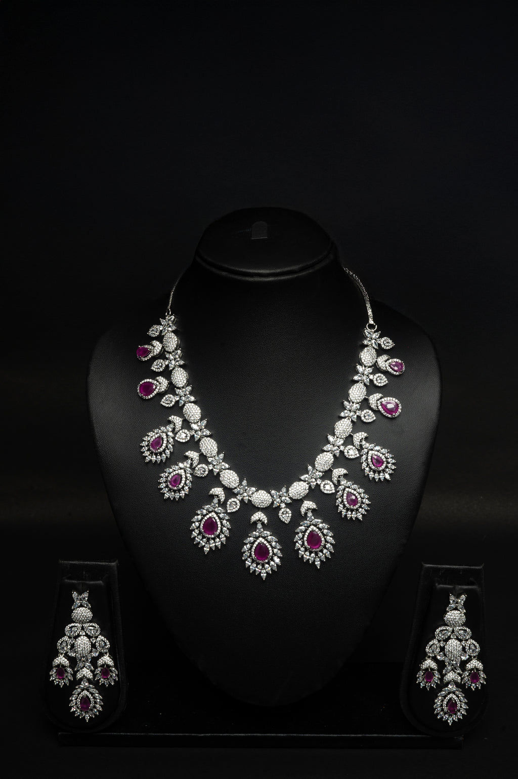 ruby Jewelry set with necklace and earrings on a black background