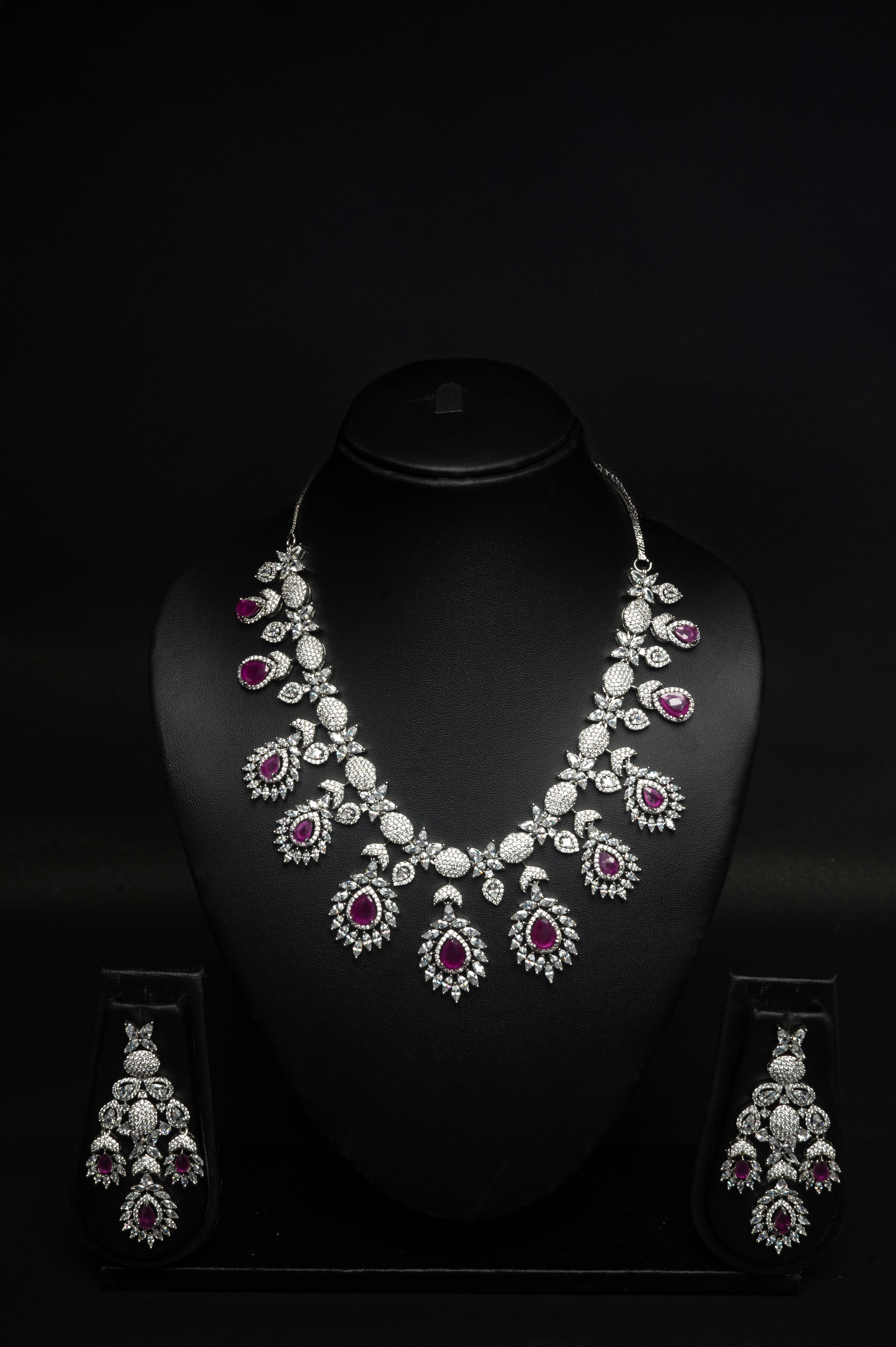 ruby Jewelry set with necklace and earrings on a black background