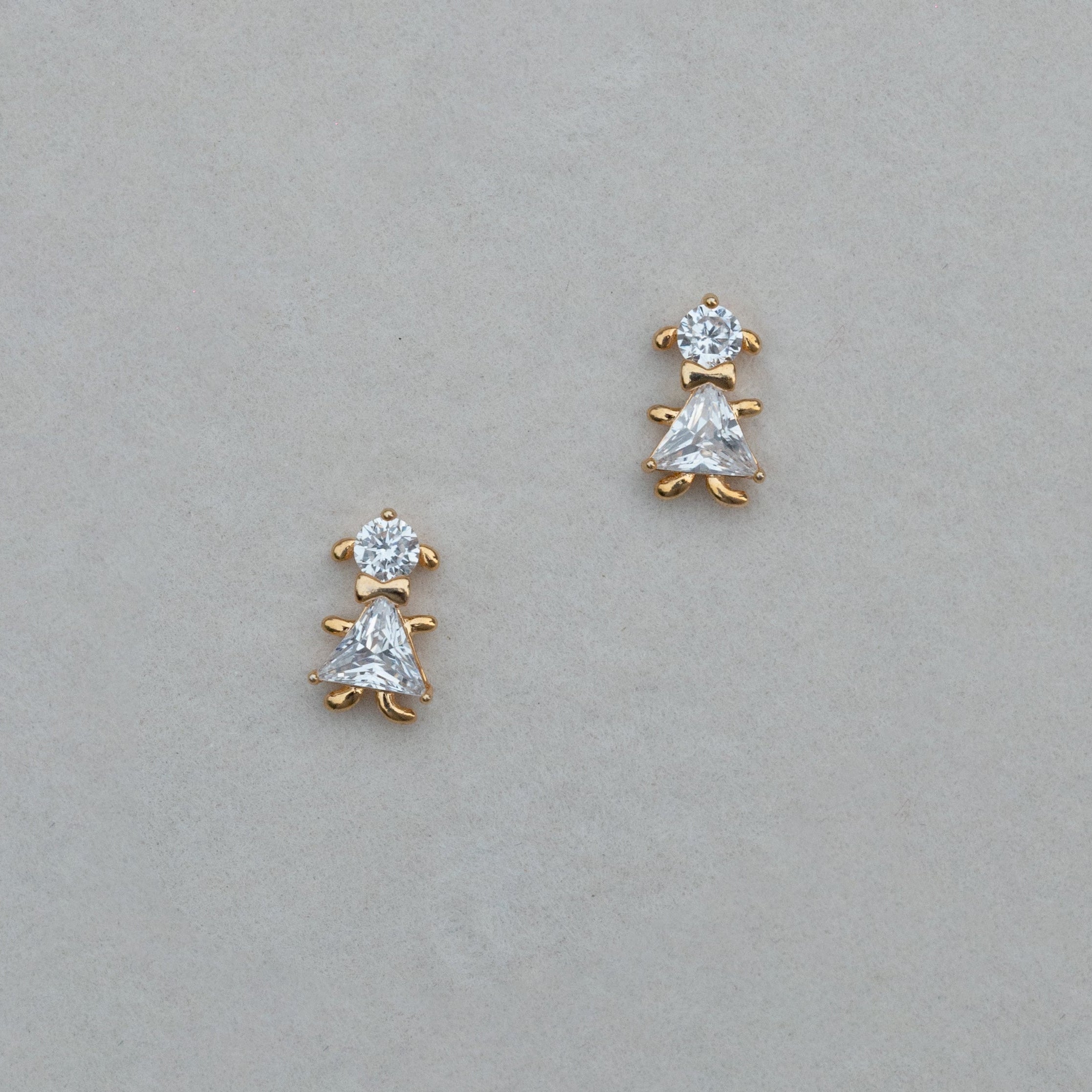Pair of diamond stud earrings on a light gray background