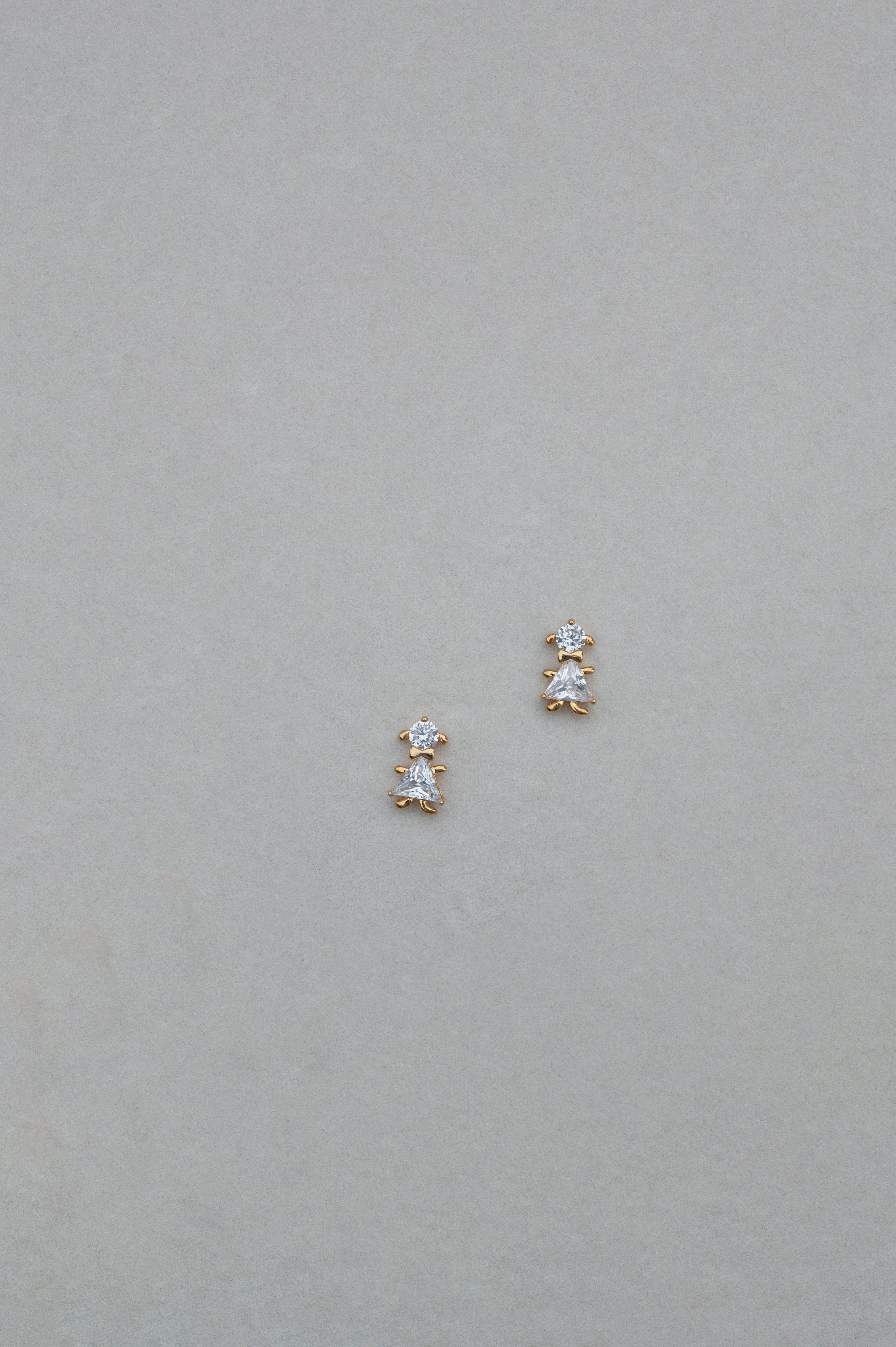 Pair of diamond stud earrings on a light gray background